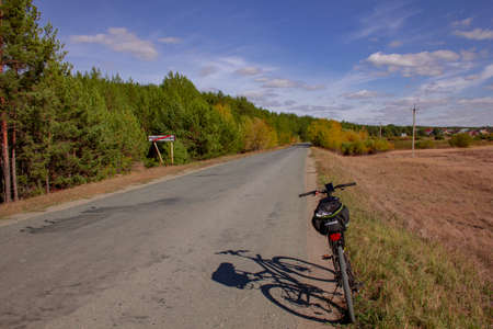 Bicycle tour of the Ural province. Autumn road to Mylnikovo. The road to the village of Mylnikovo in the Shadrinsky district of the Kurgan region of Russia.の写真素材