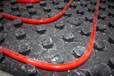 underfloor heating pipes.Red pipes of a warm water floor are laid and fixed on special panels for warm floorsの写真素材