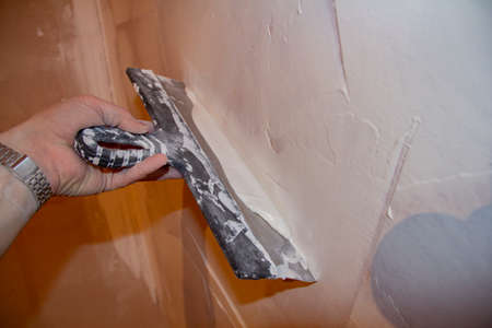puttying. putty preparation. Mixing mortar for wall putty during repairs.の写真素材