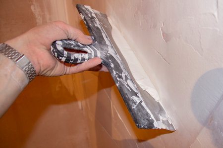 puttying. putty preparation. Mixing mortar for wall putty during repairs.の写真素材