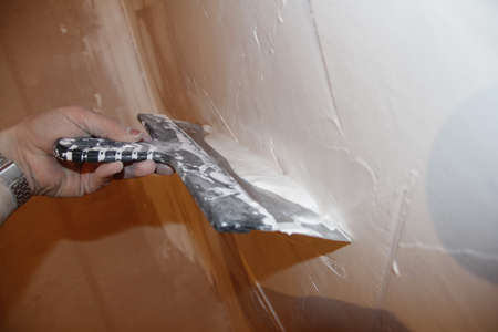 puttying. putty preparation. Mixing mortar for wall putty during repairs.の写真素材