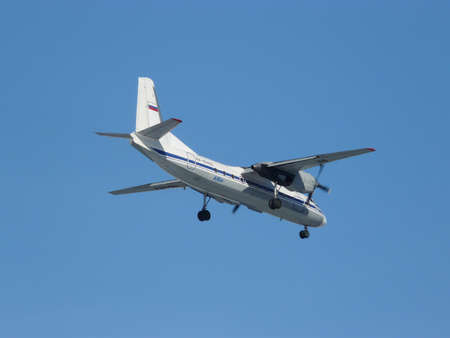 A passenger twin-engine plane is coming in to land. AN-24 aircraft comes in for landingの写真素材