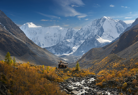 Chapel of Archangel Michael. The Belukha Massif two peaks Eastern Belukha 4509 m and Western Belukha 4435 m A beautiful autumn landscape, Russia, Siberia, mountain Altai, Katunsky ridge.の写真素材