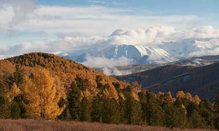 Cloudy morning. Snow-covered winter mountain lake, Russia, Siberia, Altai mountains, Chuya ridge.