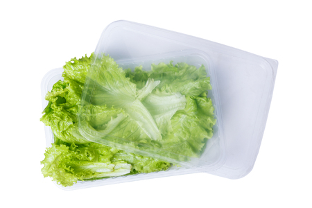 Lettuce in a plastic container isolate on white background.の写真素材