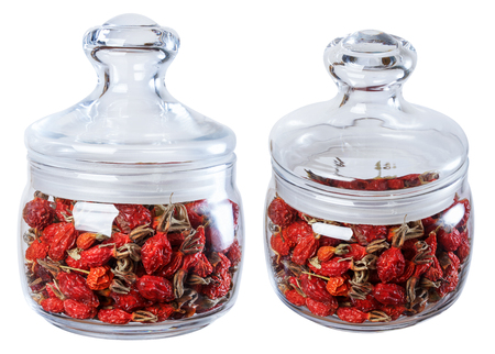 Dried wild rose in a glass jar, isolate on a white background in two ways.の写真素材