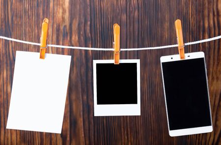 Photo templates hanging on a rope, secured with pegs. Photo concept reflecting evolution. Film...
