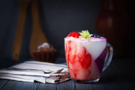 Panna-cotta, dessert. Jelly, whipped cream pudding of berries and gelatin. A cupcake, a rough cloth napkin and a dessert spoon. Picture, picture.の写真素材