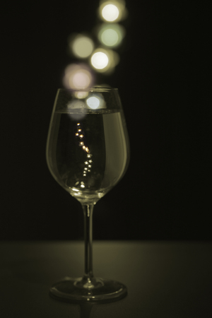 Glass of champagne with colored bubblesの写真素材