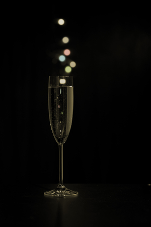 Glass of champagne with colored bubblesの写真素材