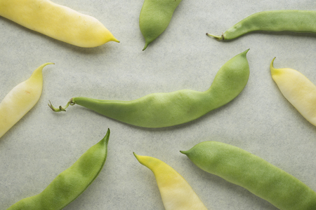 Yellow and green beans on a blur background.
