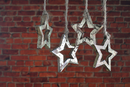 Christmas garland of wooden star on a background of red bricks.の写真素材