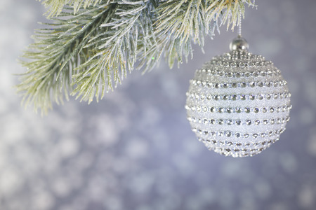 Beautiful diamond Christmas ball on a silver background bokeh.の写真素材