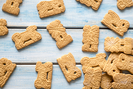 Christmas biscuits figure on a blue wooden table.の写真素材