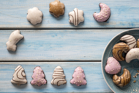 Christmas gingerbread coated on a blue wooden table.の写真素材