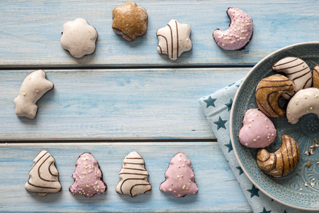 Christmas gingerbread coated on a blue wooden table.の写真素材