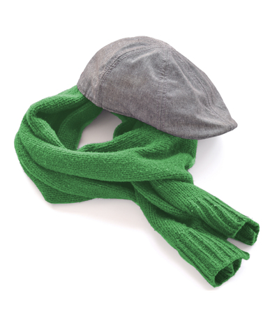 Gray cap and green warm scarf on a white backgroundの写真素材