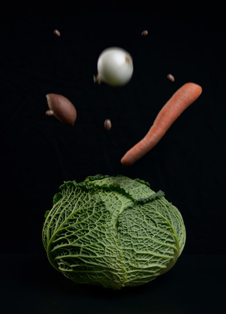 Ripe vegetables for soups and salads on a black background.の写真素材