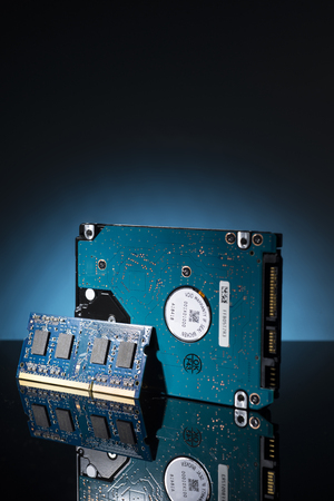 Computer parts on a black background with blue backlight.
