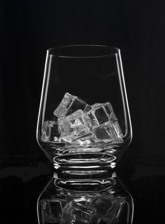 Beautiful glass with ice on a black backgroundの写真素材