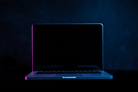 Portable modern silver computer on a black background.の写真素材