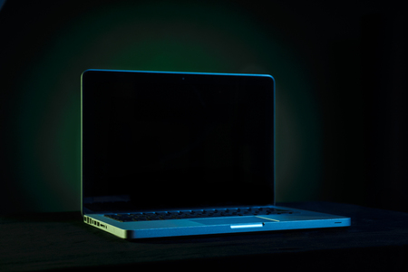 Portable modern silver computer on a black background.の写真素材