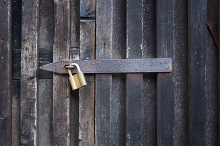 Padlock on a wooden wall. On wooden gates.の写真素材