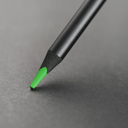 Close up of green pencil on black background. Shallow depth of field.の写真素材