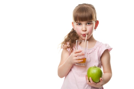 Portrait of happy little girl drinking  juice and holding green apple  Isolated on white  Health conceptの写真素材