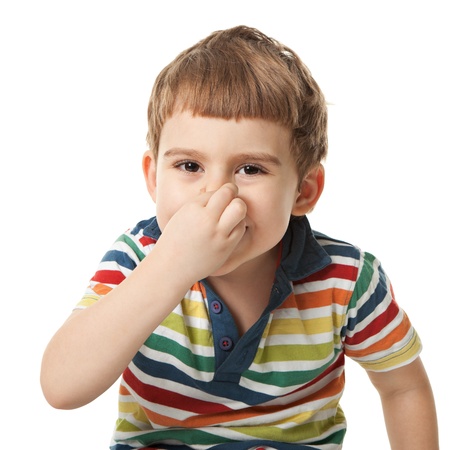 cheerful smiling little boy touches the nose. Isolated on white background.  shooting in the studioの写真素材