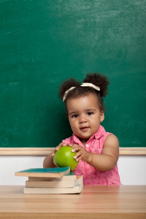Cheerful smiling child  girl  at the blackboard  School conceptの写真素材