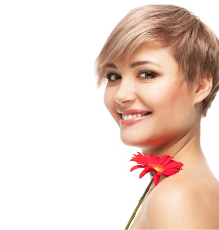 Portrait of beautiful smiling young woman with a flower. Taken in the studio.の写真素材
