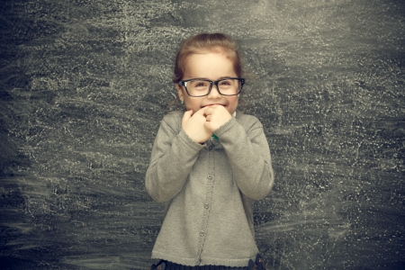 Beautiful smiling girl on a black background  School conceptの写真素材