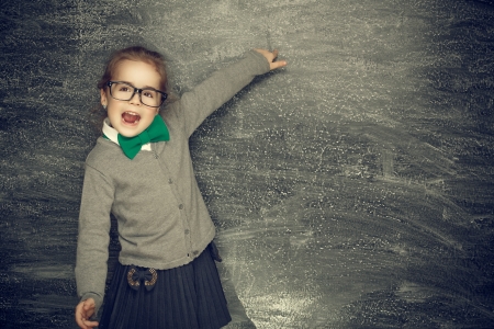 Beautiful smiling girl on a black background  School conceptの写真素材