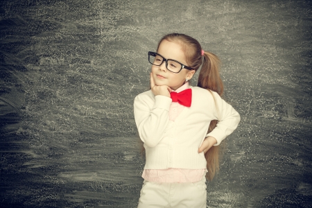 Beautiful smiling girl on a black background  School conceptの写真素材
