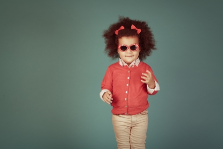 Vintage happy african girl against green background.の写真素材