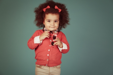 Vintage happy african girl against green background.の写真素材