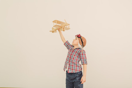 Cheerful smiling kid  boy l in helmet on a green background  Vintage pilot  aviator  conceptの写真素材