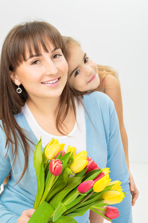 Picture of mother and daughter with flowers. Mother day conceptの写真素材