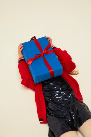 Smiling funny child (kid, girl) in Reindeer Hairband holding Christmas gifts in hand. christmas concept. Shooting on white backgroundの写真素材