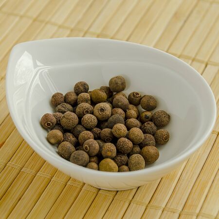 Seasoning allspice in a white bowl close-up. 12の写真素材