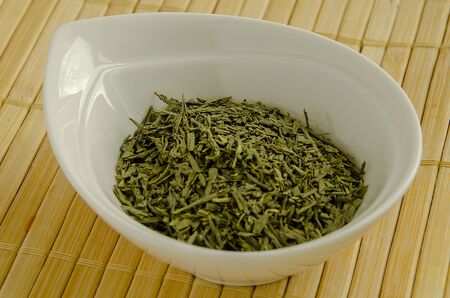 Rosemary seasoning in a white bowl close-up.の写真素材