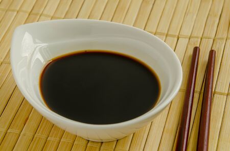 Soy sauce in a white bowl close-up.の写真素材