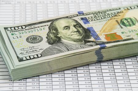 Banknotes dollars on the background of a quote sheet.の写真素材
