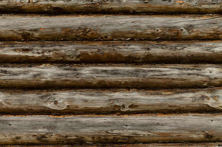 The texture of the wall is made of old logs.の写真素材