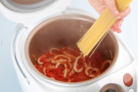 The process of cooking pasta with squid in Multicookerの写真素材