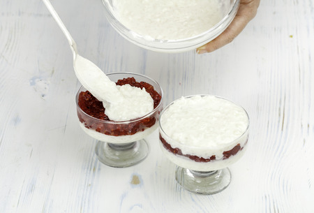 cooking three-layered rice pudding with red currants closeupの写真素材