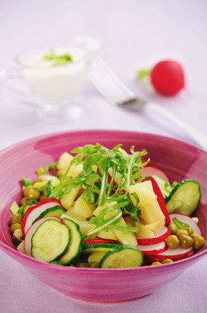 appetizing salad with potatoes, radish and cucumber closeupの写真素材