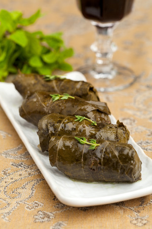stuffed cabbage rolls in grape leaves on a decorated table closeupの写真素材