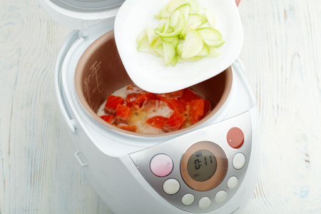 cooking fried salmon with leek in multicooker closeupの写真素材